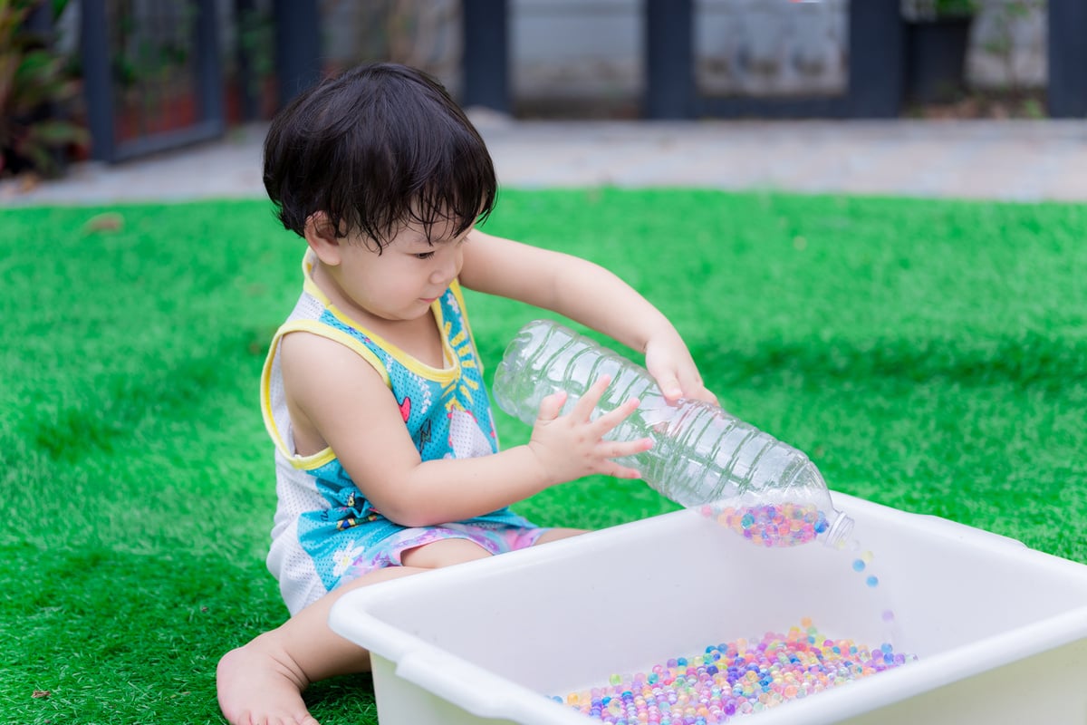 Little Boy Playing with a Sensory Water Bottle